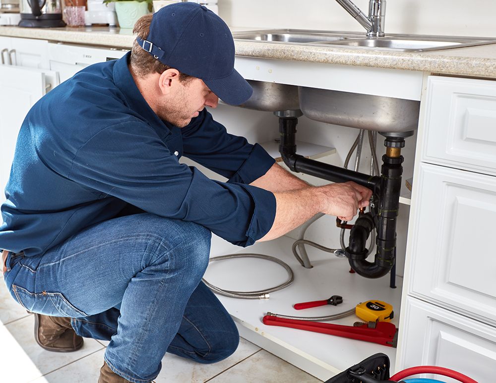 Plumber repairing a sink drain